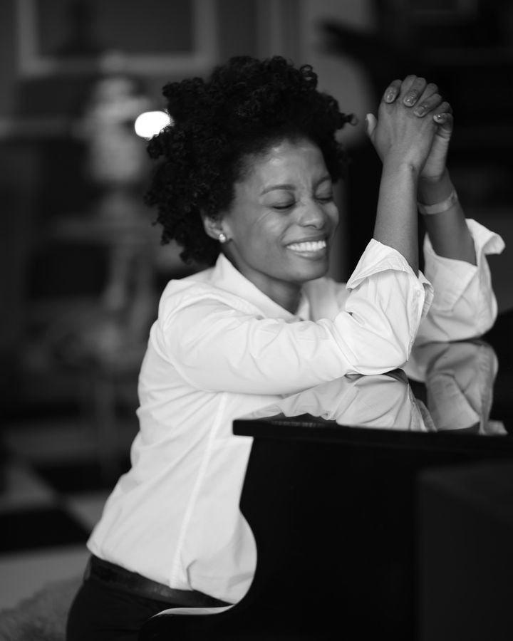 Maud Nale laughing with her eyes closed, in black and white